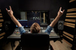 Man at mixing console in music recording studio