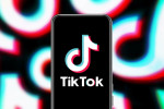 Mobile phone displaying the TikTok logo against a background made up of a mashup of TikTok logos for the article: Creating TikTok Ads For Bands And MusiciansCreating TikTok Ads For Bands And Musicians