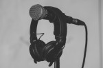 Headphones resting on a microphone in studio