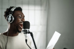 Recording artist singing into microphone
